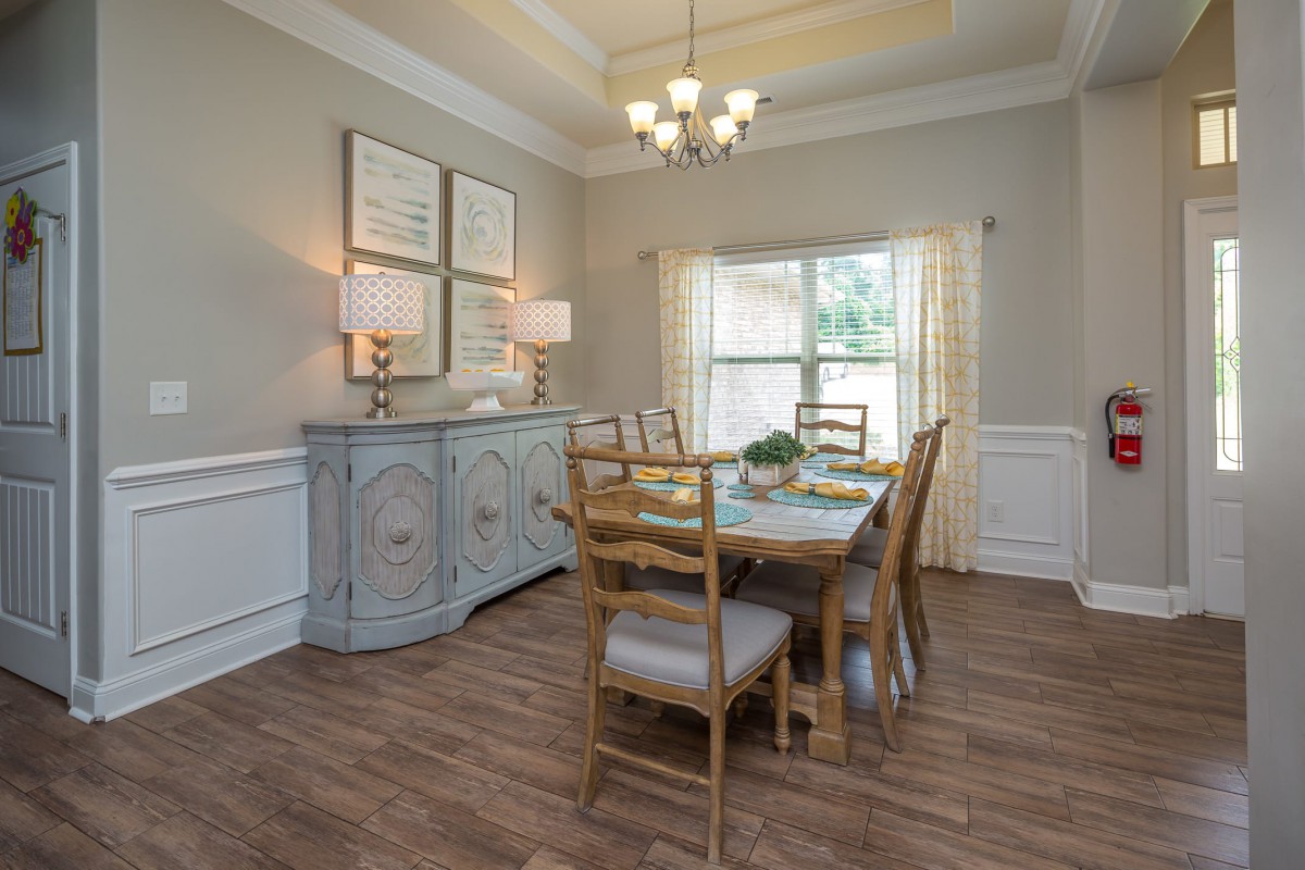 A cozy dining room with elegant decor and natural lighting.