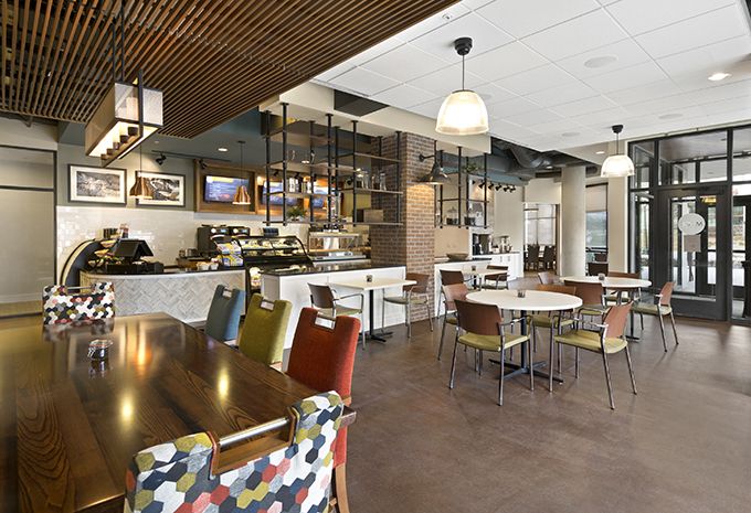 A modern cafe interior featuring diverse seating and contemporary lighting.