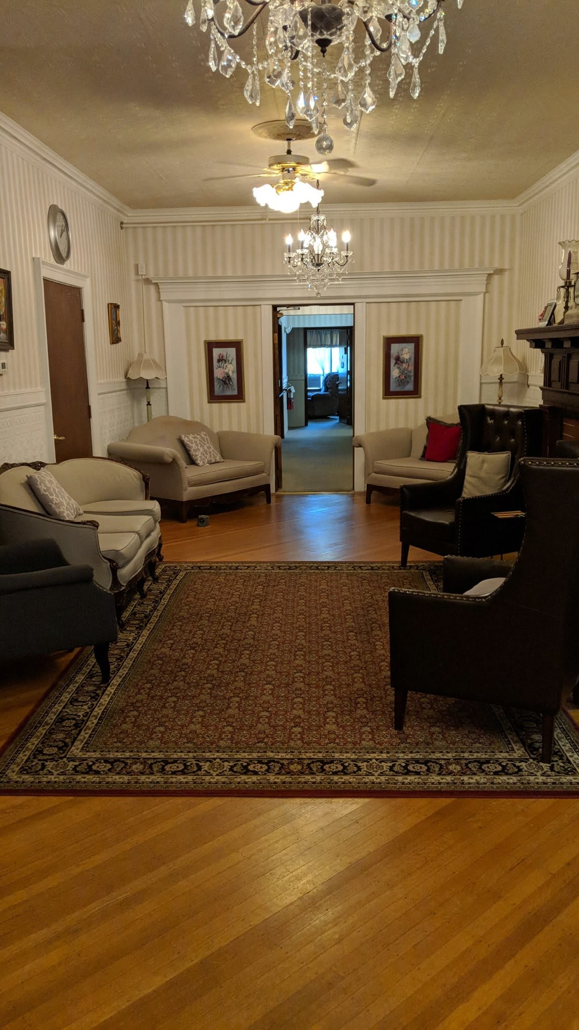 A cozy living room with elegant furnishings and a chandelier.
