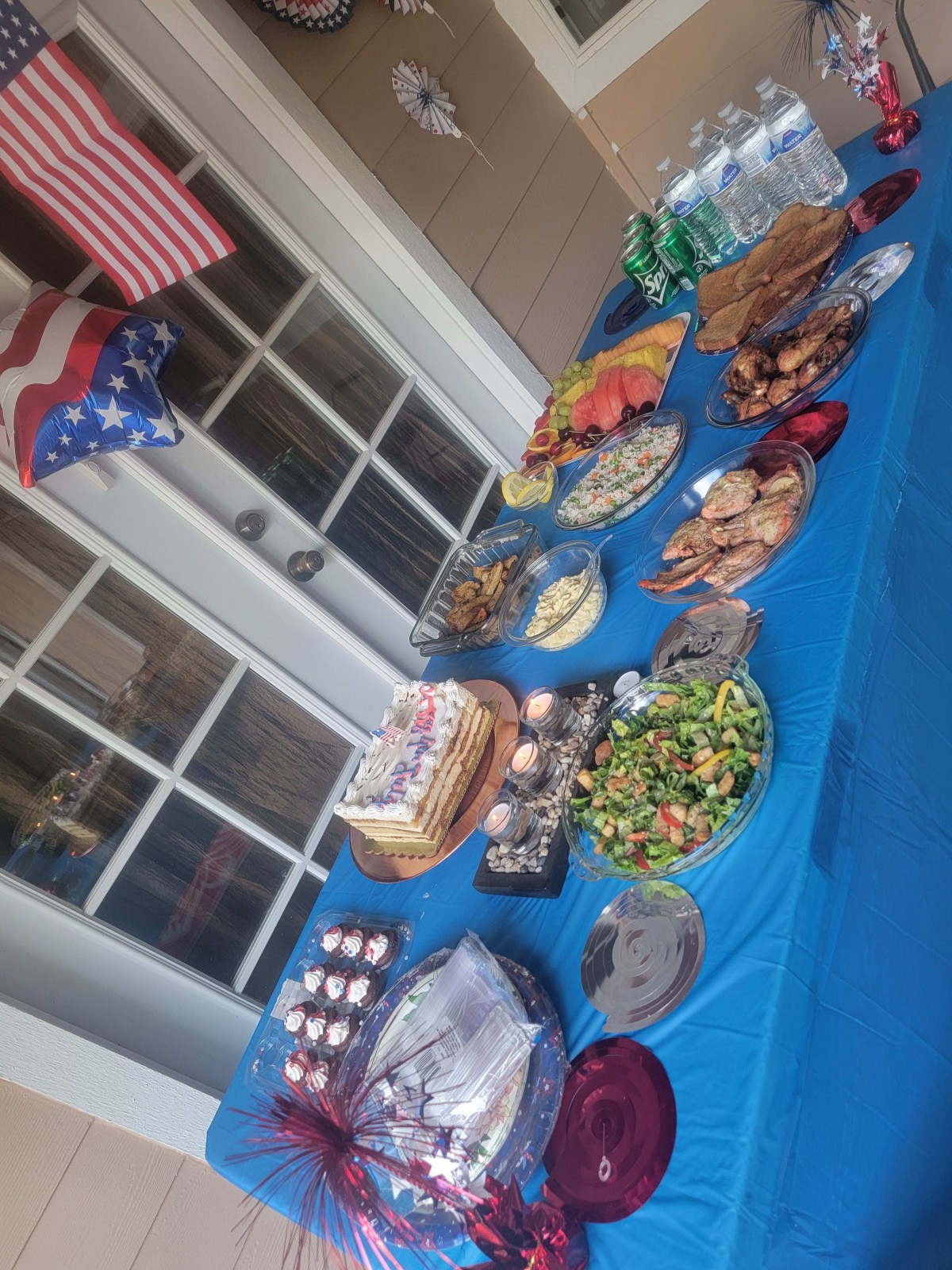 A festive table setup with a variety of foods and patriotic decorations.