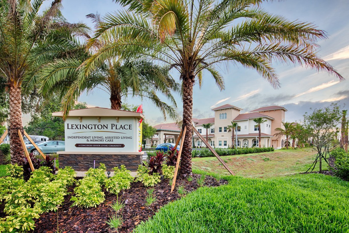 A modern apartment complex named 'Lexington Place' surrounded by well-maintained landscaping and palm trees.
