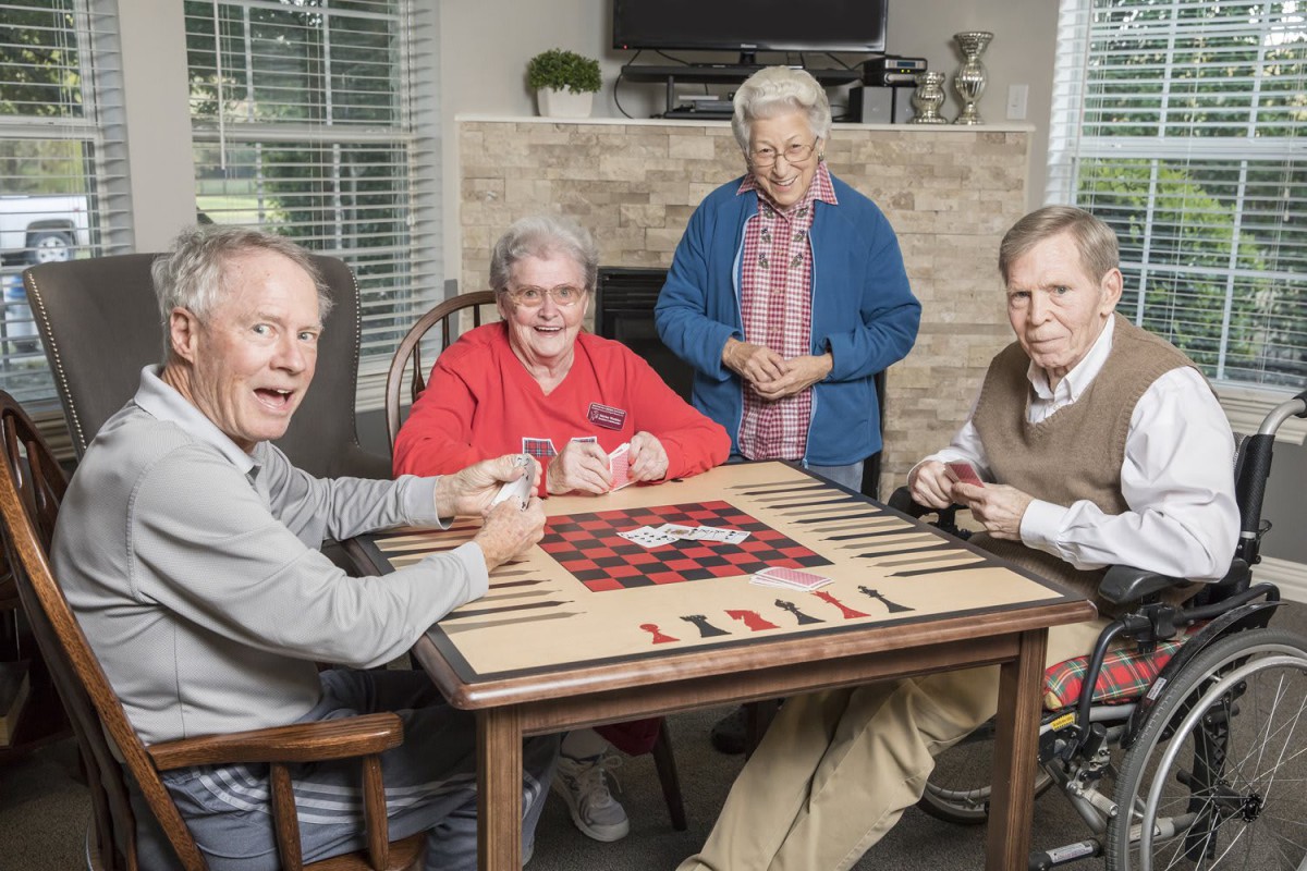 A group of seniors enjoying a card game at a table.