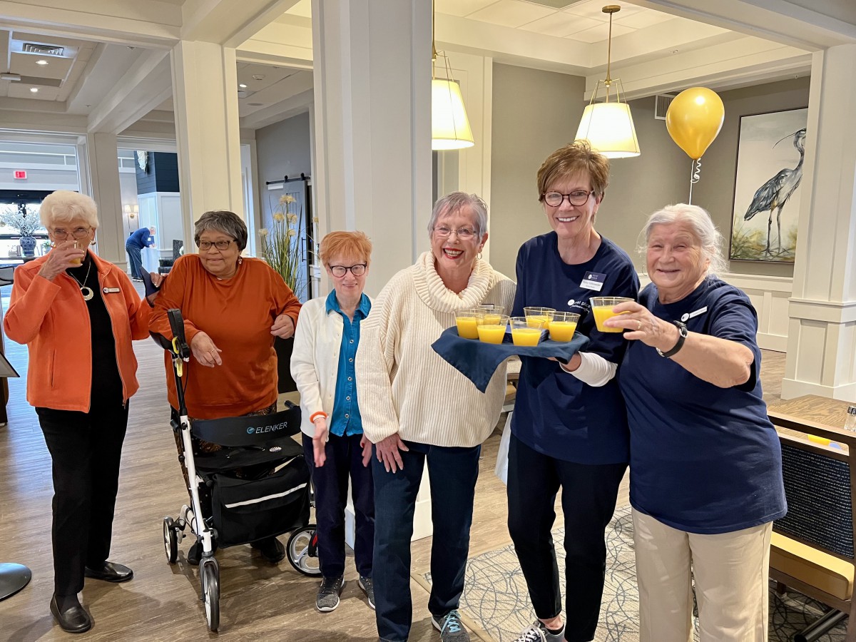 A group of seniors enjoying a celebratory gathering indoors.