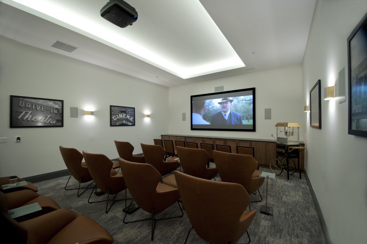 A cozy home theater setup with comfortable seating and a large projection screen.
