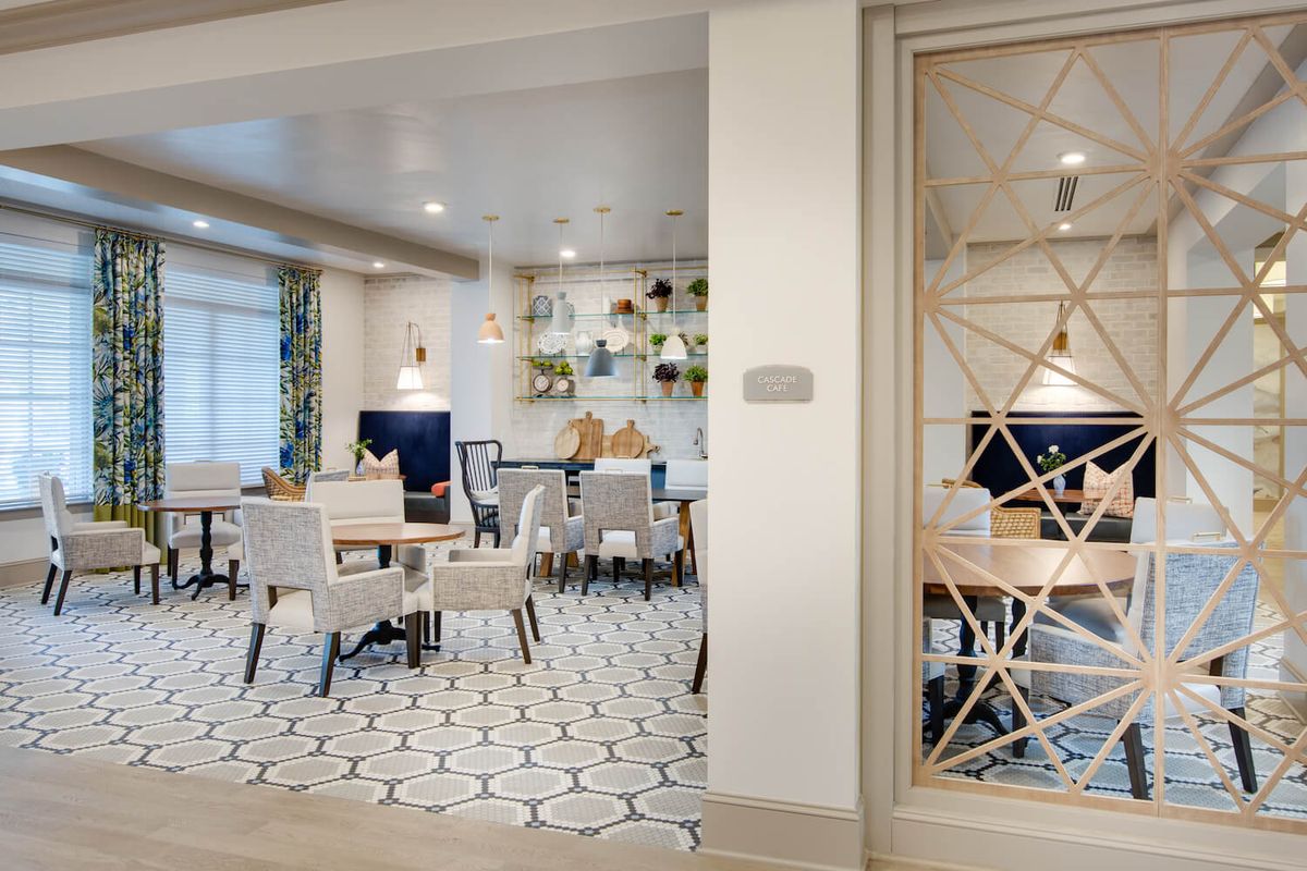 A modern dining area featuring contemporary furniture, geometric patterns, and stylish lighting.