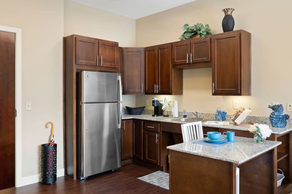 A modern kitchen with stainless steel appliances and wooden cabinets.