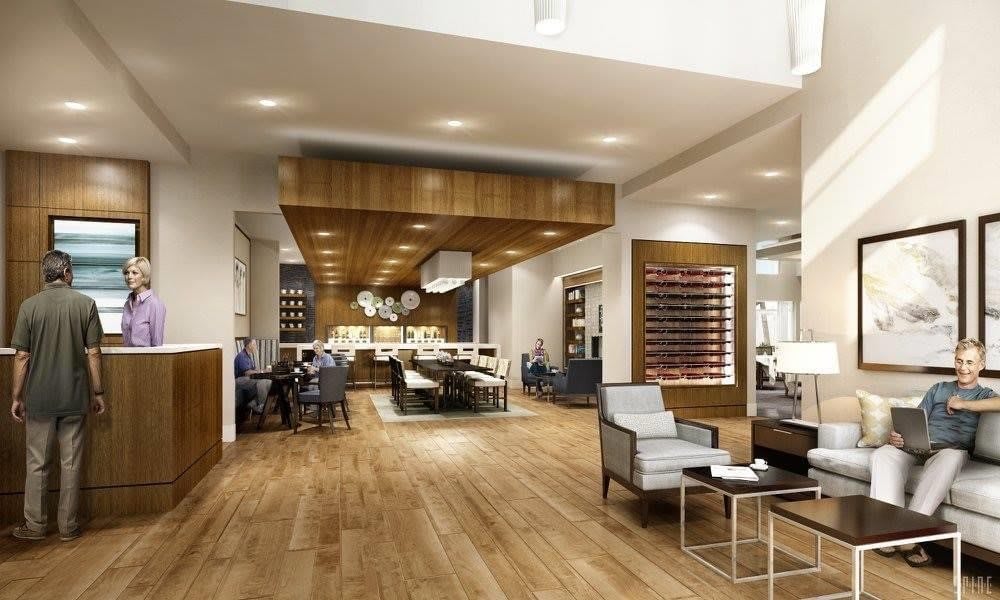 A modern living room with open space and warm wooden flooring.
