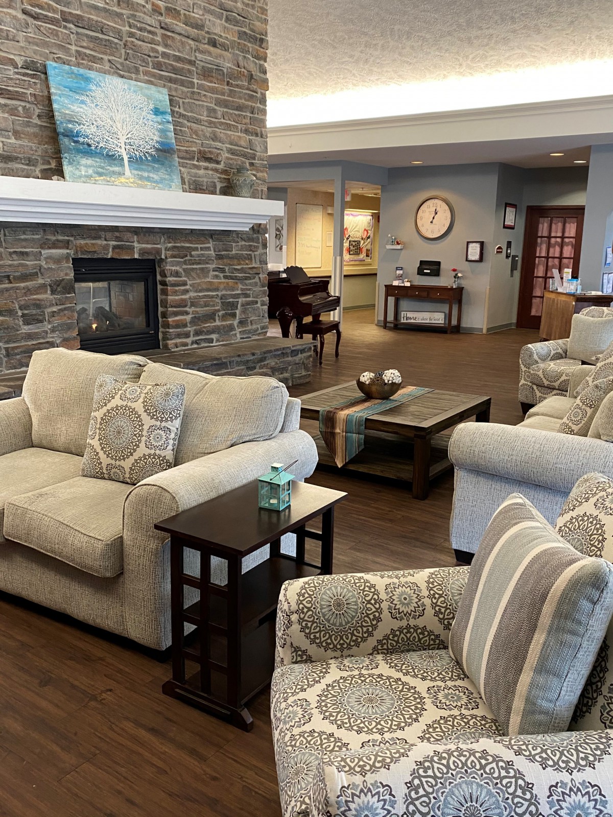 A cozy living room with plush seating and a fireplace.