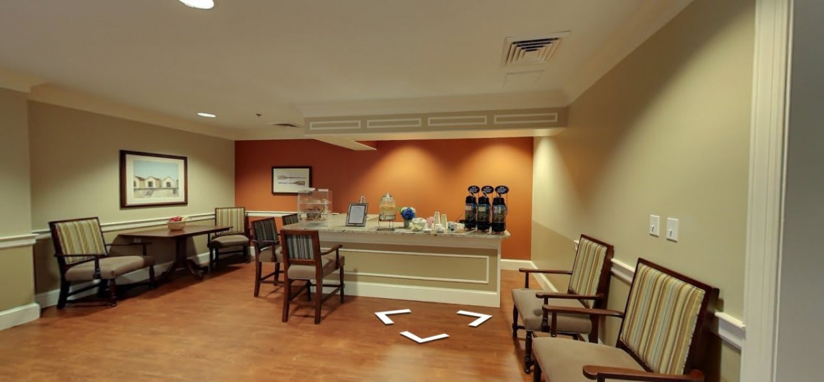 A cozy waiting area with a coffee station and comfortable seating.