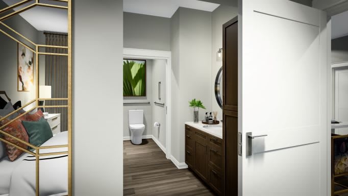 A modern bathroom with a sleek design, featuring wooden cabinets, a round mirror, and minimalist decor.