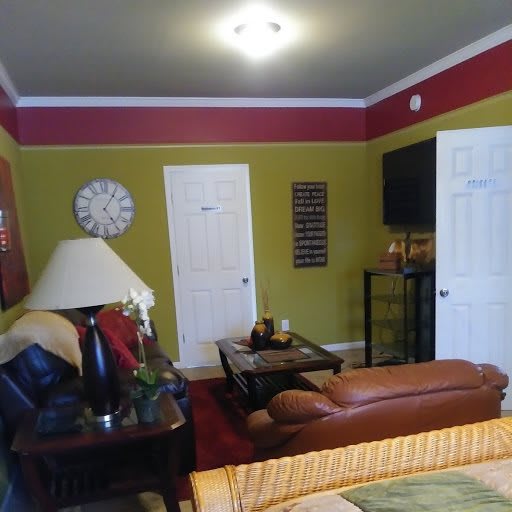 A cozy living room with colorful walls and comfortable furnishings.