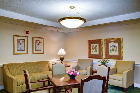 A cozy living room with comfortable seating, a table, and elegant decor.