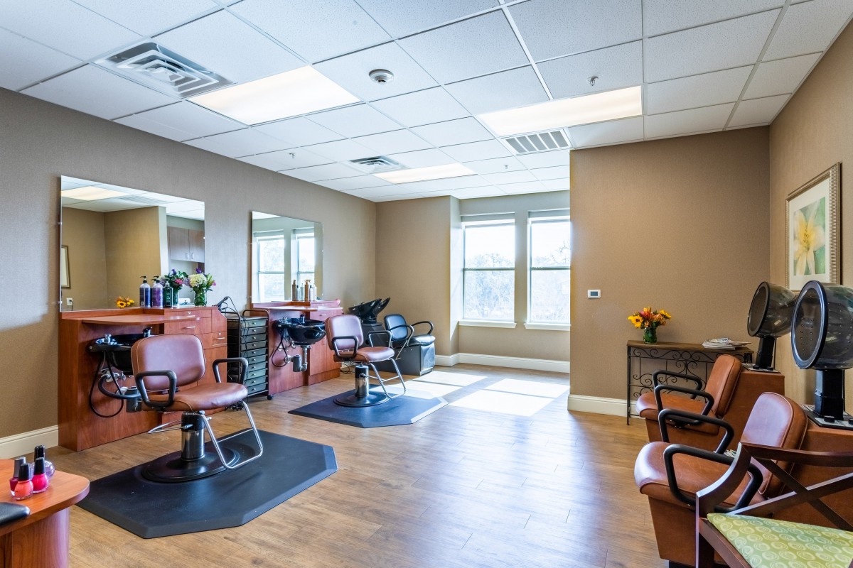 A bright and spacious hair salon with multiple styling stations.