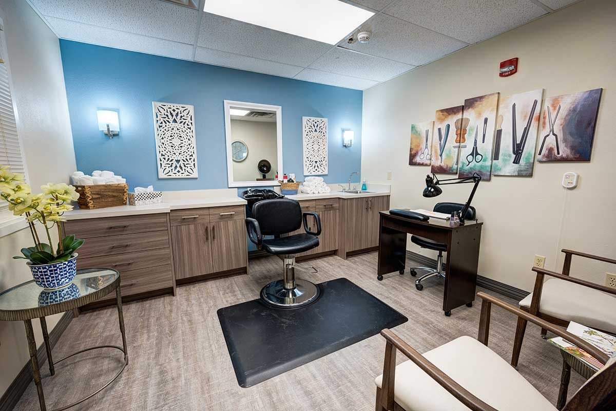 A modern hair salon interior with a central styling chair and wall decorations.