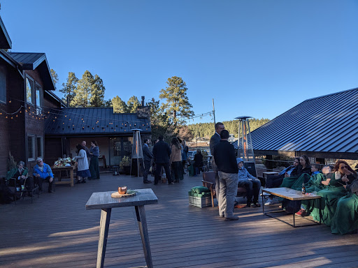 A vibrant outdoor gathering on a sunny day, with people enjoying the company amidst nature.