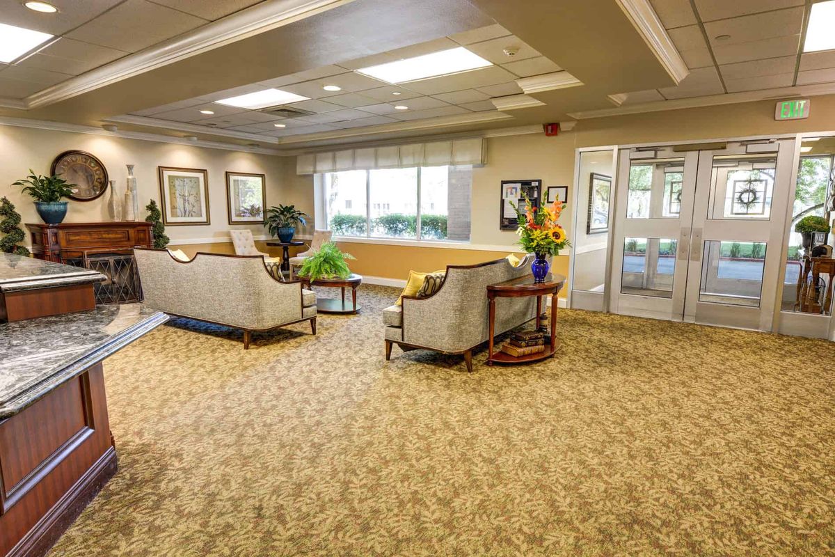 A well-furnished lobby area with comfortable seating and natural lighting.