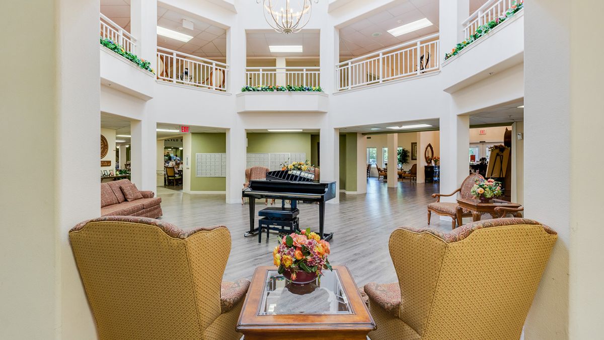 A well-furnished lobby featuring a grand piano and elegant seating area.