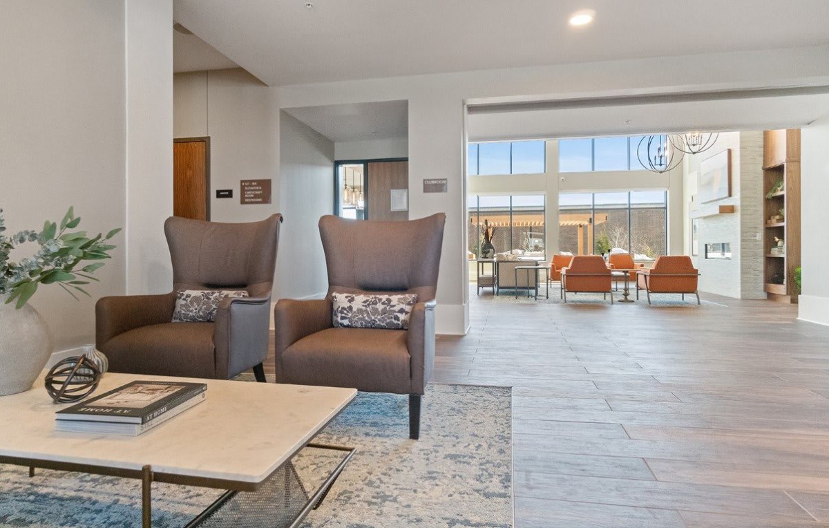A modern living room with stylish chairs and a spacious, sunlit open area.