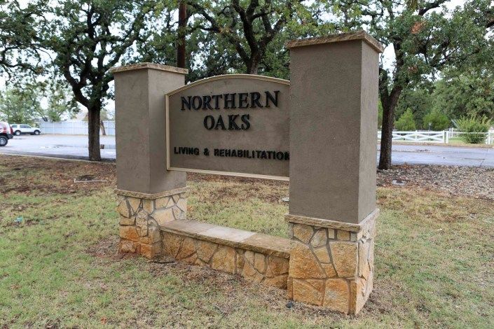 A sign for Northern Oaks Nursing & Rehabilitation, set in an outdoor landscape.