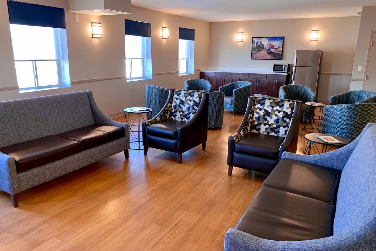 A cozy lounge area featuring various seating options, including sofas and armchairs.