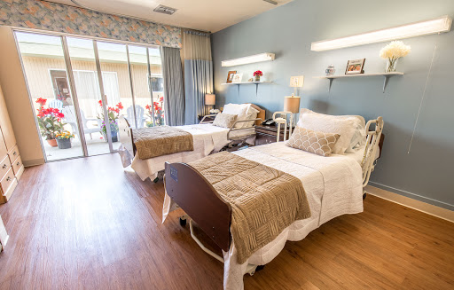 A well-lit and inviting patient room featuring two beds and a serene environment.