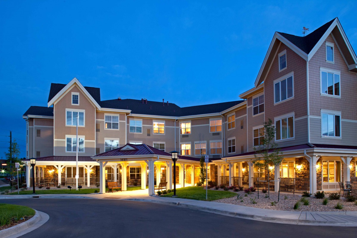 A well-lit hotel exterior during the night.
