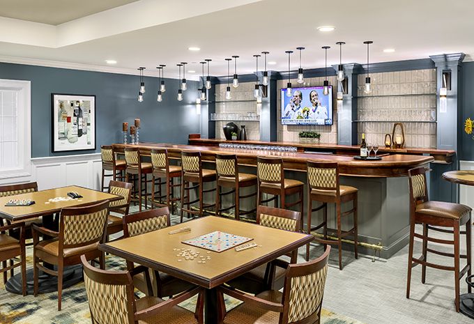 A modern bar and restaurant interior with seating and a television.