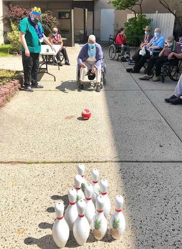 Residents enjoying a fun bowling game outside.
