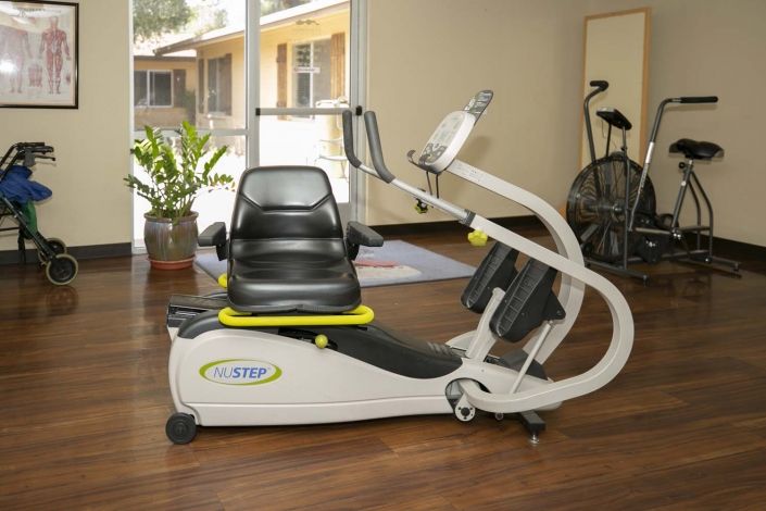 A modern recumbent exercise bike in a home gym setting.