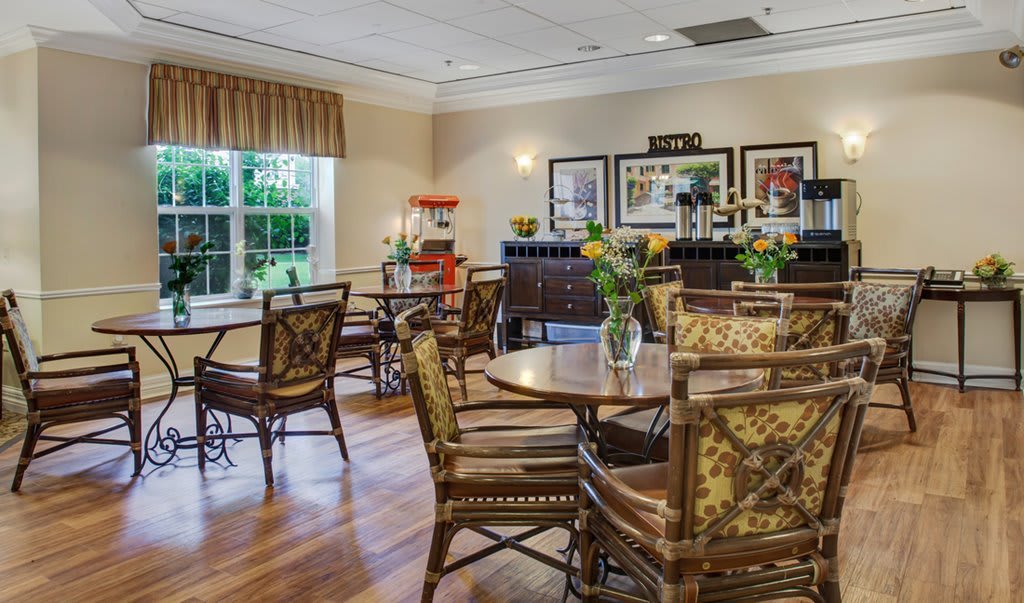 A cozy cafe interior with decorative seating and tables.