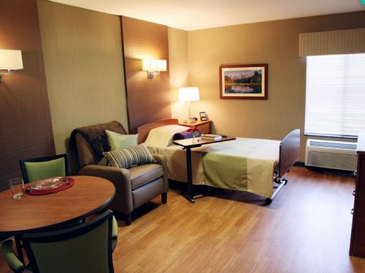 Cozy and inviting hotel room featuring a comfortable bed, living area, and natural light.
