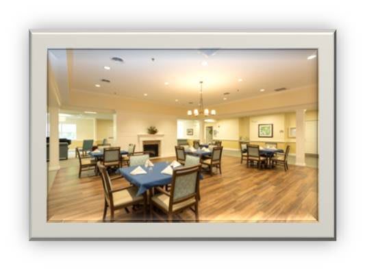 A well-lit dining area with multiple tables and chairs arranged neatly.