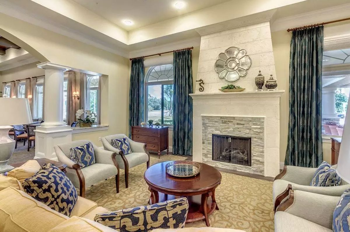 A cozy living room with elegant furniture and a fireplace centerpiece.