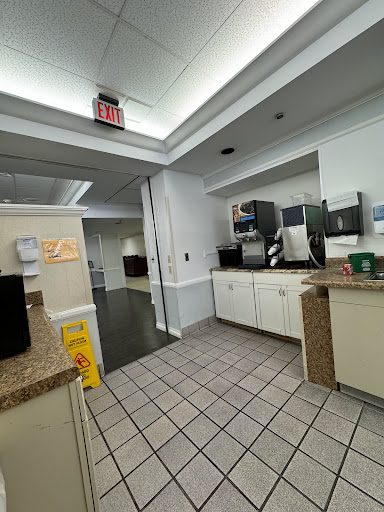 A view of a clean office kitchen space equipped with appliances.