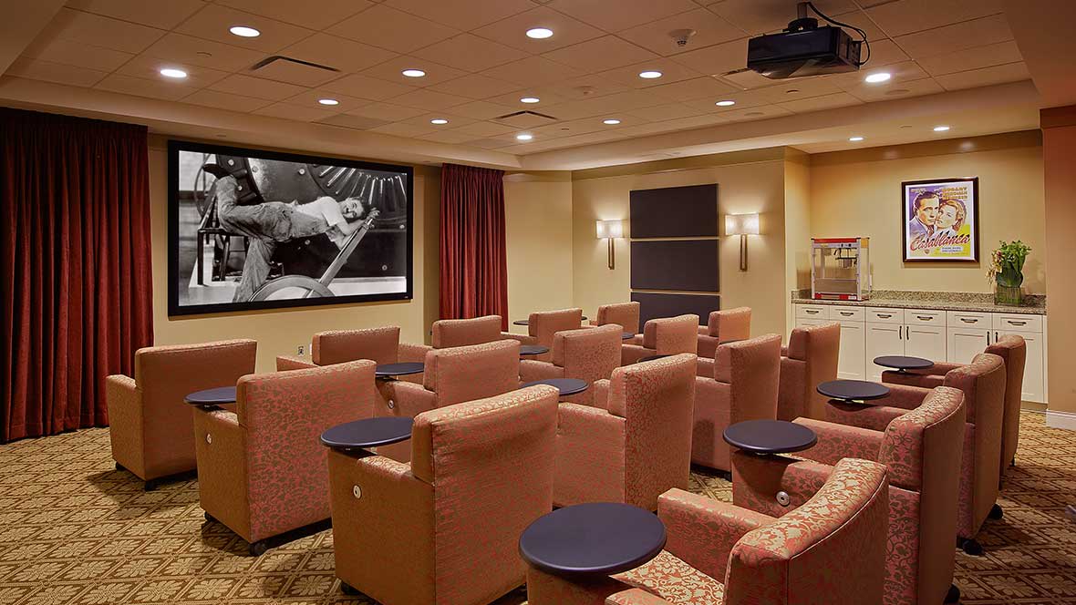 A cozy home theater setup with comfortable seating and a large screen.