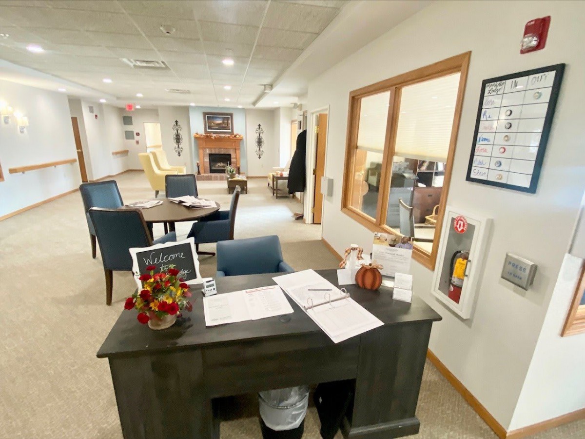 A welcoming office reception area with a desk and seating arrangement.
