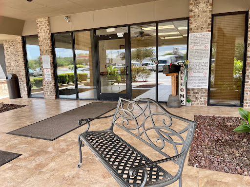 A welcoming entrance area featuring a decorative bench and glass doors.