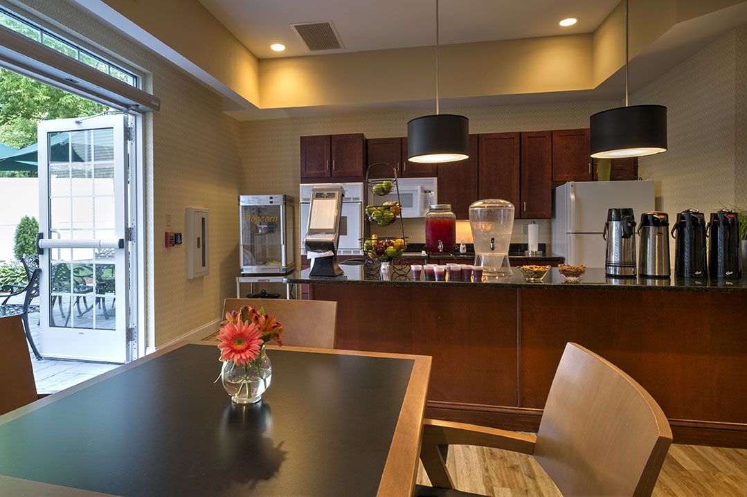 A cozy kitchen and dining area with a modern breakfast bar setup.