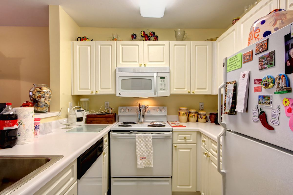 A cozy kitchen with white cabinets and modern appliances.