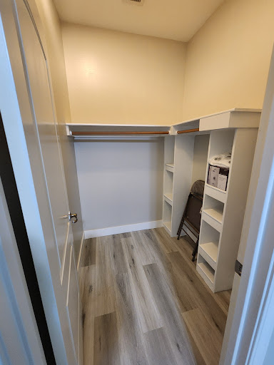 A spacious closet featuring built-in shelves and a clean, organized layout.
