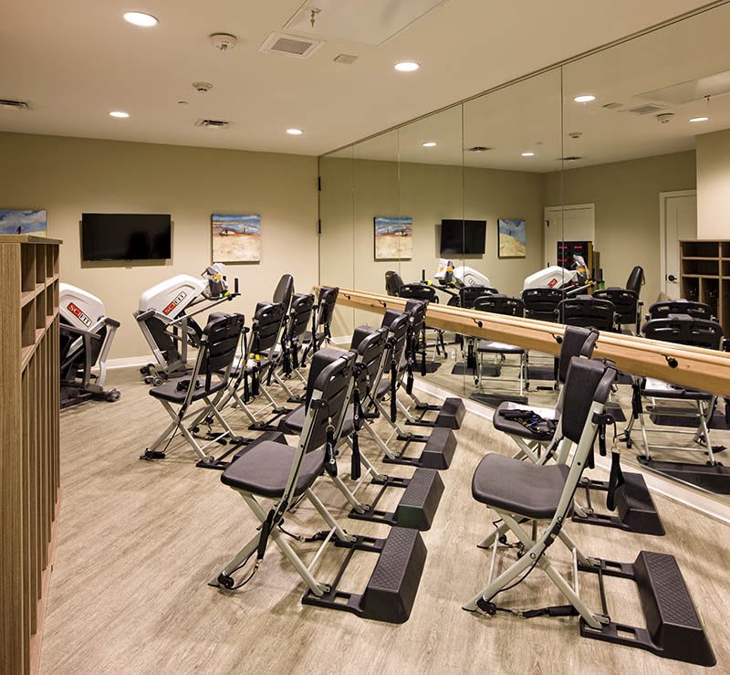 A fitness studio with exercise chairs and mirrored walls.