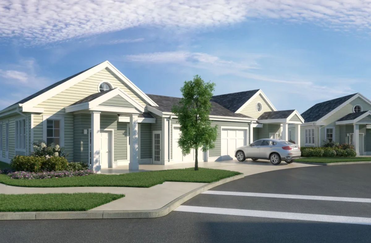 A suburban residential neighborhood with modern houses and neatly maintained lawns.