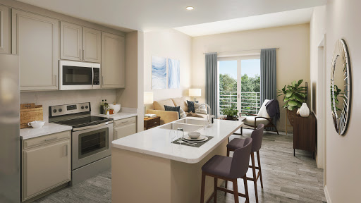 A bright and modern kitchen featuring sleek appliances, an expansive island, and inviting seating area with a view.