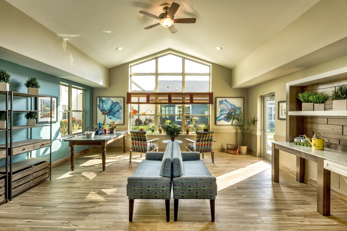 Spacious living area with ample natural light and modern furnishings.