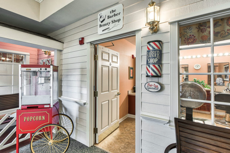 Entrance to a charming barber and beauty shop with vintage decor.
