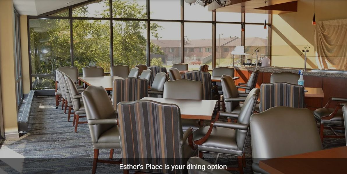 A cozy dining area with chairs and tables, offering a pleasant window view.