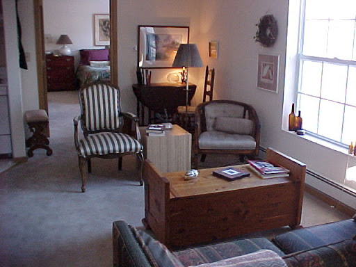 A cozy living room featuring a mix of seating options and warm lighting.