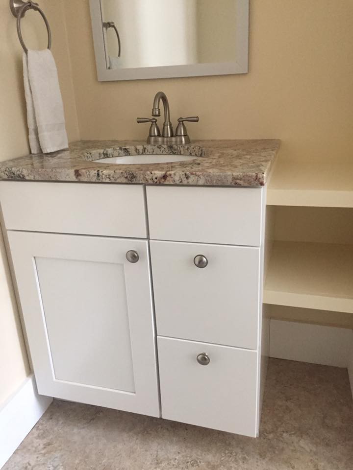 A bathroom vanity with a marble countertop and built-in sink.