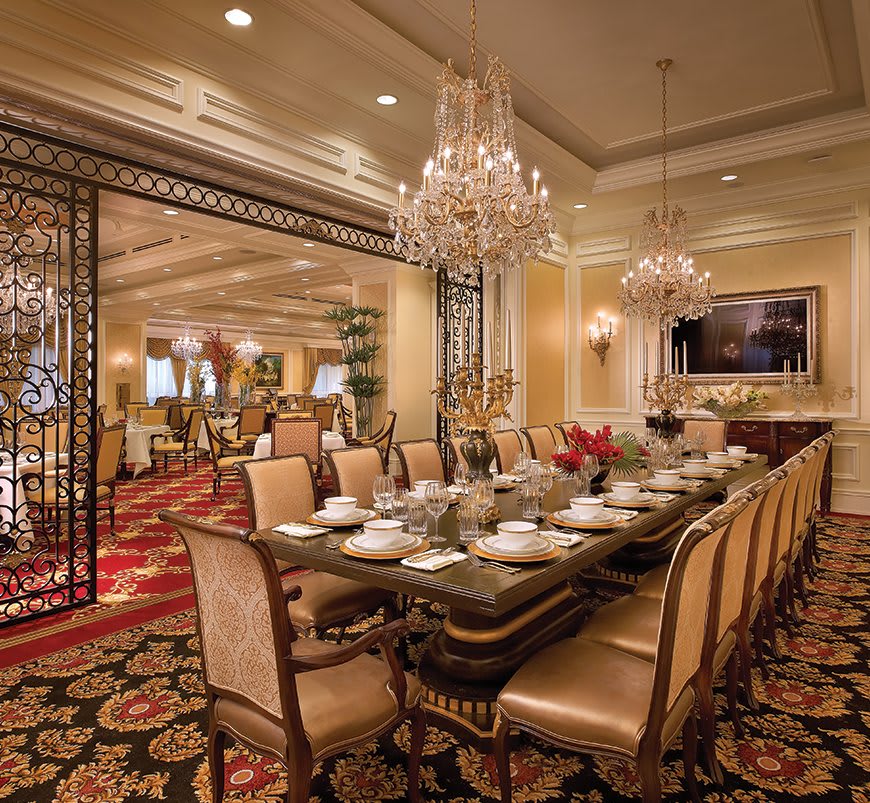 A luxurious dining room with elegant decor and grand chandeliers.