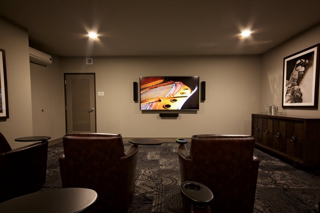 A cozy home theater setup with comfortable seating and a large screen.